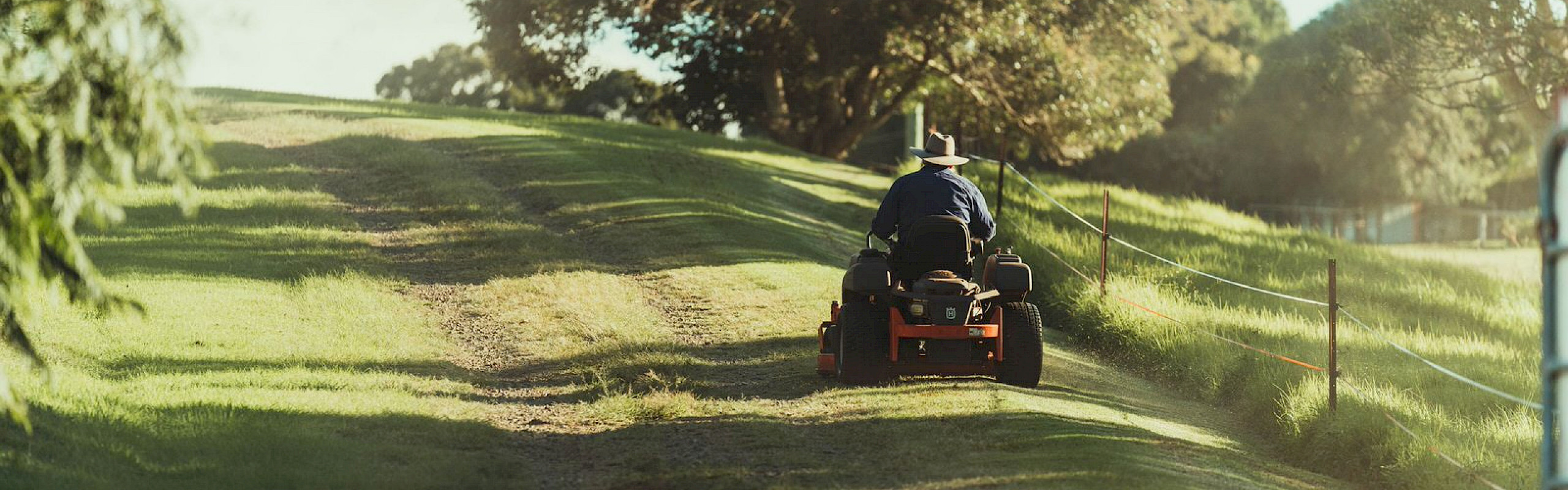Four wheel lawnmower traveling up a hill